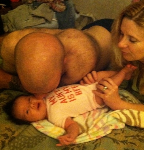 Homem beija bebê no rosto, mas foto chama atenção por ‘detalhe estranho’